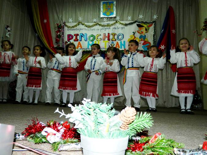 Copii in costume traditionale, pe scena unei serbari